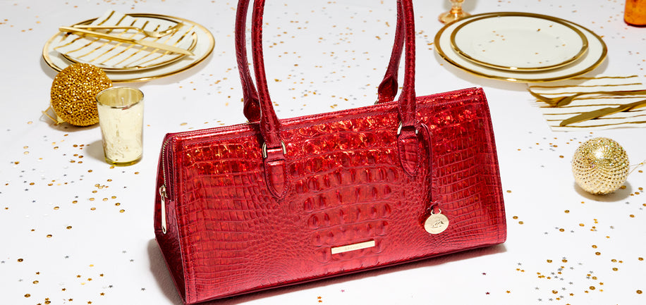 Red Opal Melbourne Sophia handbag on a white surface with gold decorative elements