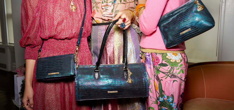 Three sisters holding Minuette, Sophia, and Lorelei handbags