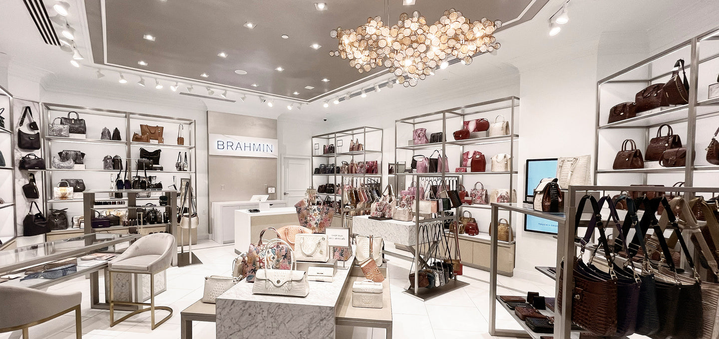 Brahmin retail store interior showcasing premium leather handbags, modern visual merchandising, and luxury fashion careers in retail.