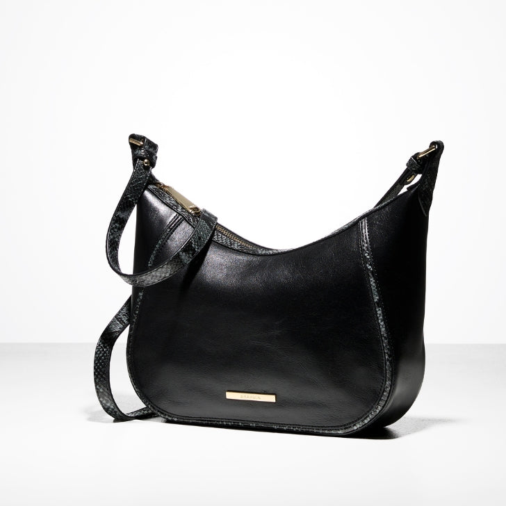 Brahmin black leather hobo bag with a smooth curved silhouette, minimal gold hardware, and a slim adjustable shoulder strap, photographed on a clean studio background.