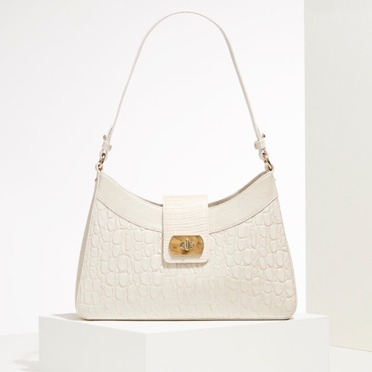 Elegant ivory Brahmin Esme shoulder bag with crocodile embossing and chic wooden twist-lock closure.