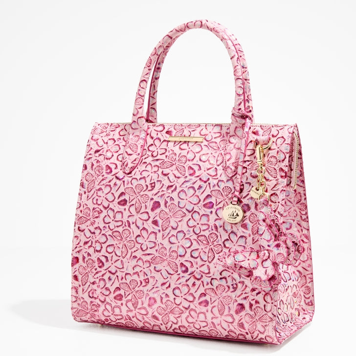 Brahmin Fearless Collection Caroline tote handbag in pink floral embossed leather with structured silhouette, rolled handles, gold hardware, and signature medallion charm, designed in partnership with National Breast Cancer Foundation to empower and give back.