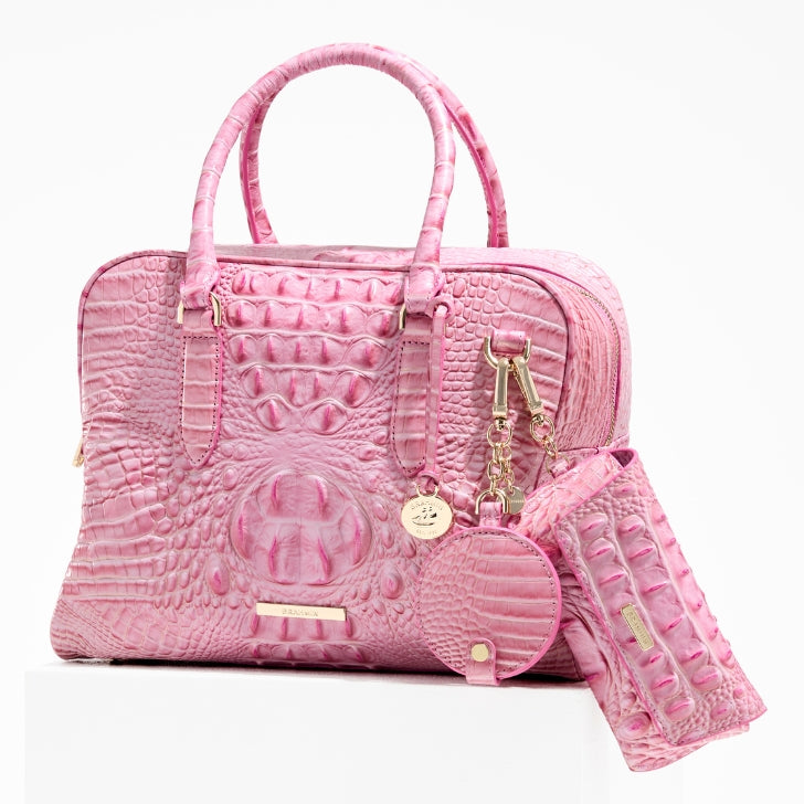 Brahmin Fearless Collection Marissa satchel in pink croc-embossed leather featuring top zip closure, double rolled handles, gold hardware, and coordinating accessories including wristlet and round coin pouch, supporting the National Breast Cancer Foundation.