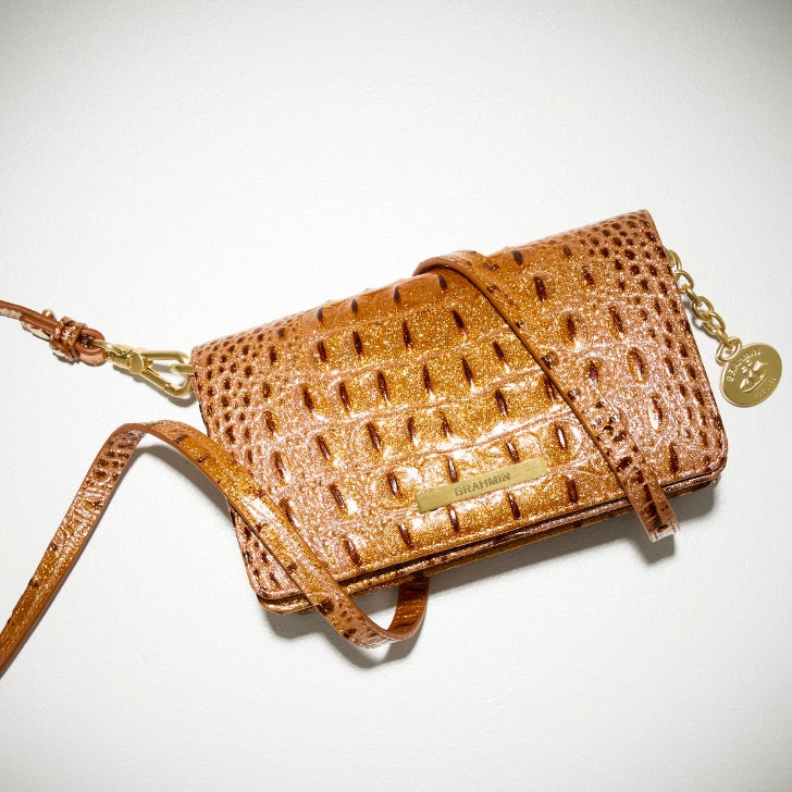 Brahmin metallic bronze crossbody bag with embossed croc texture, gold logo plate, and detachable strap.