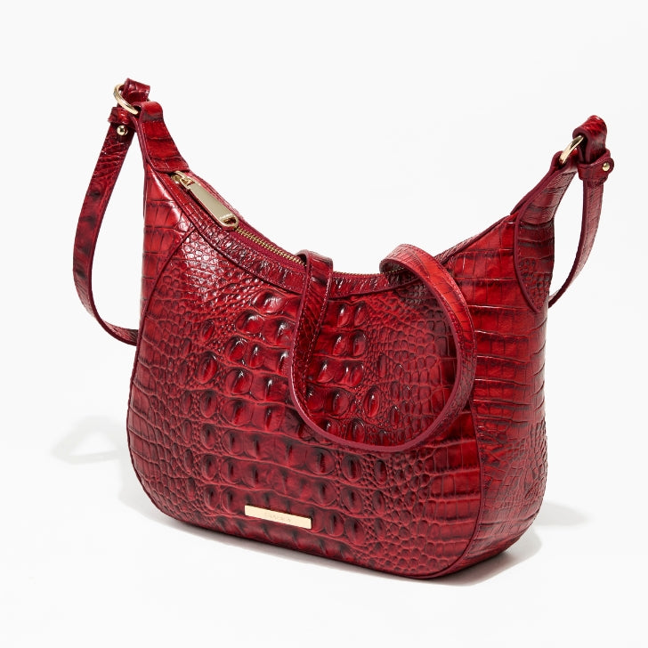 Glossy burgundy croc‑embossed leather hobo bag with curved silhouette, gold nameplate, and single top strap on white background.